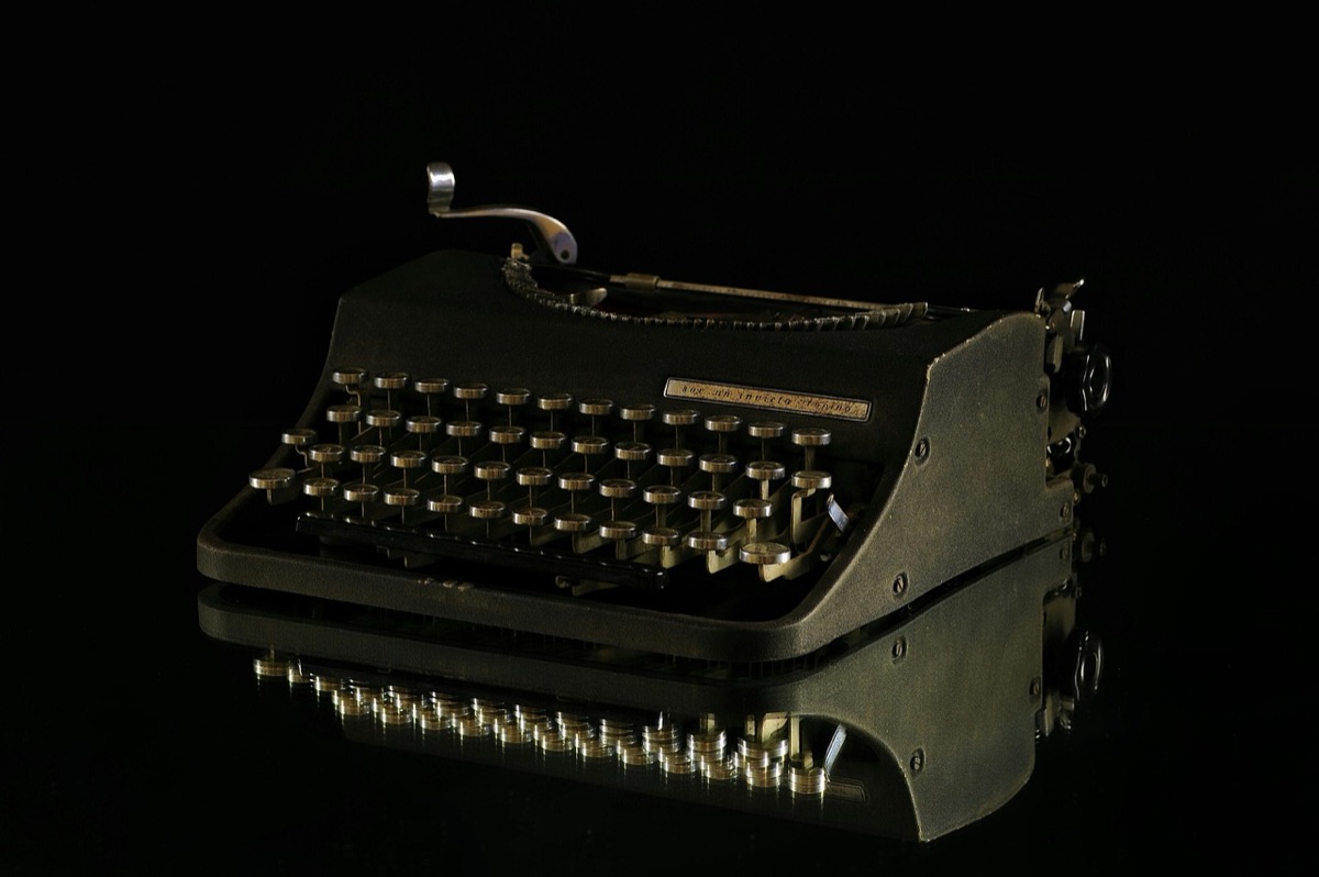 Journalist at a cluttered desk comparing sources