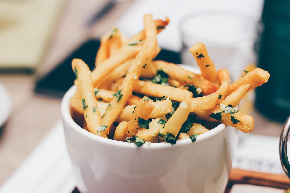 Close-up of crispy golden french fries in an air fryer basket