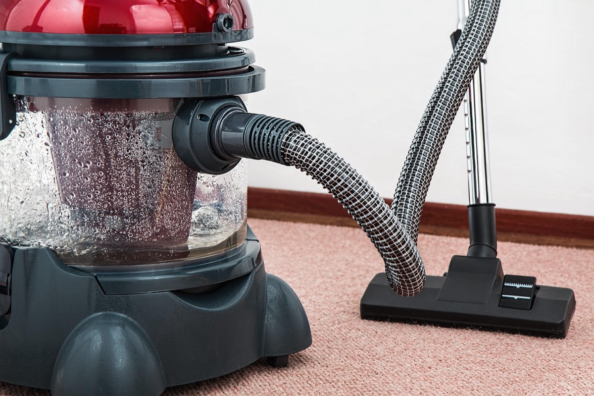 Wireless vacuum cleaner on tiled kitchen floor