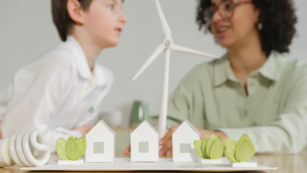 Children engage in learning about renewable energy with wind turbines and eco-friendly models in a classroom setting.