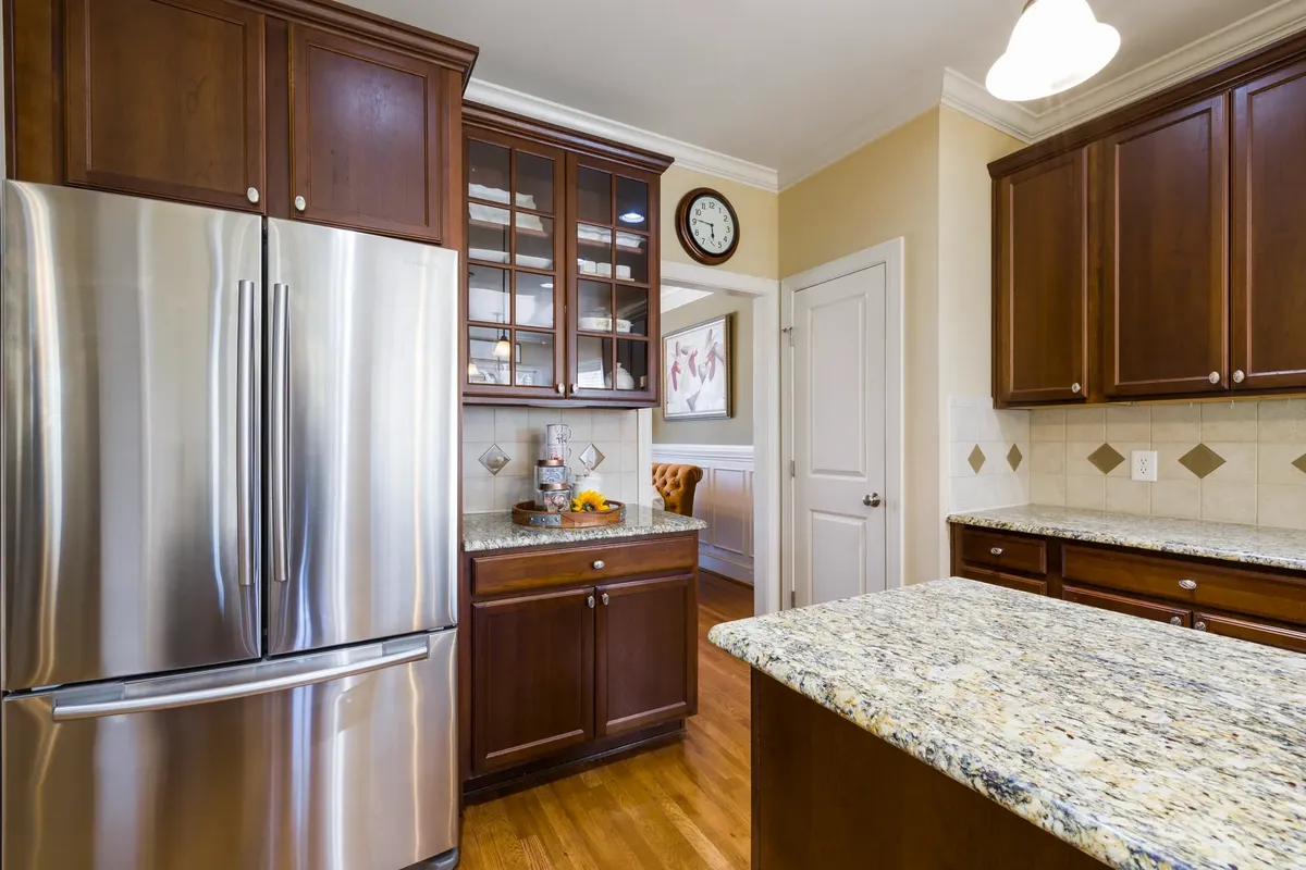 Spacious kitchen featuring stainless steel appliances and elegant wood cabinetry with granite countertops.
